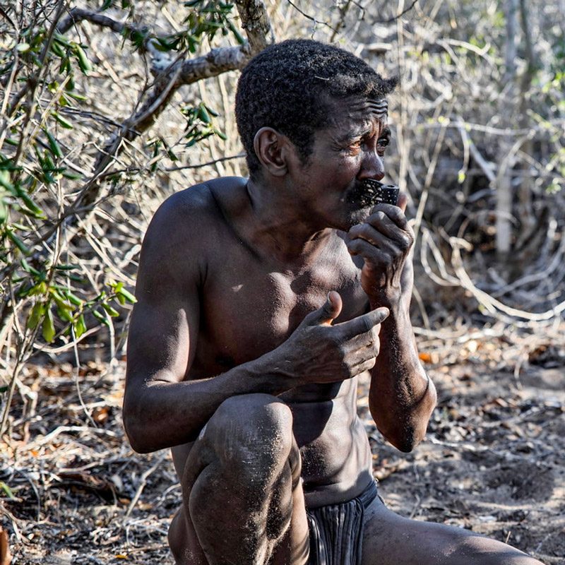 Mikea man smoking with a pipe during trip to Madagascar
